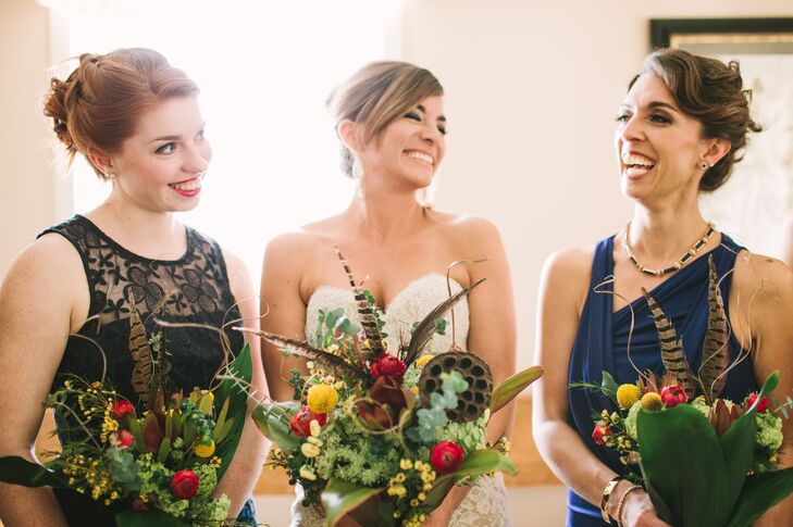 The bride and bridesmaids carried pheasant feathers, billy balls, lotus pods, ranunculus and wildflowers in their organic bouquets.
