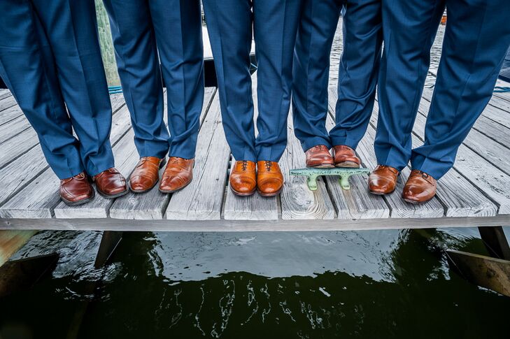 The groomsmen wore navy suits in keeping with the bride and groom's nautical wedding theme. They paired their navy suits with colorful ties from Vineyard Vines and tan dress shoes.