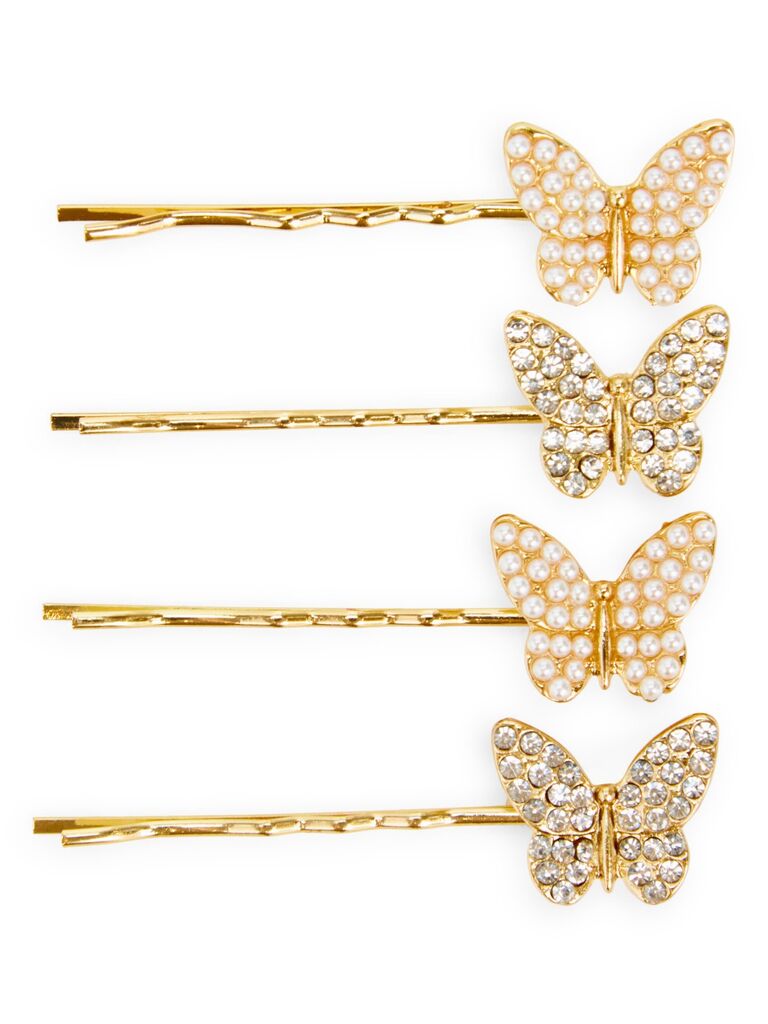 Bobby pins featuring gold butterflies embellished with rhinestones and pearls. 