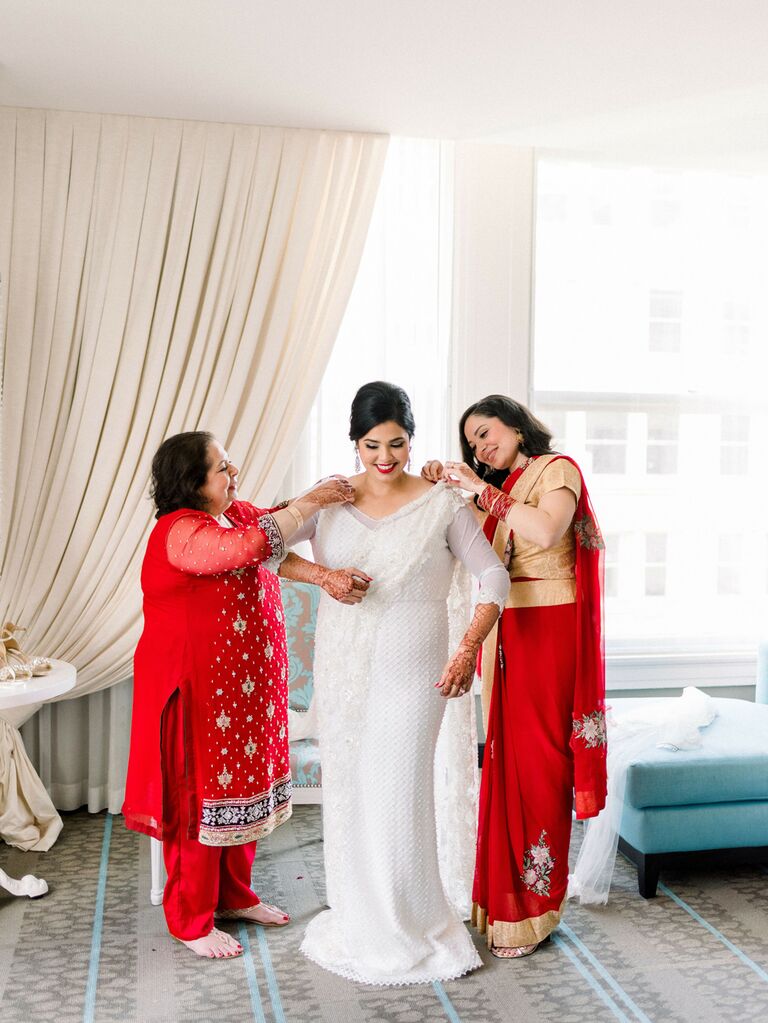 Bride getting ready with mother before wedding