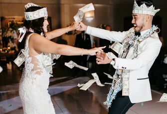 Couple engages in a traditional money dance. 