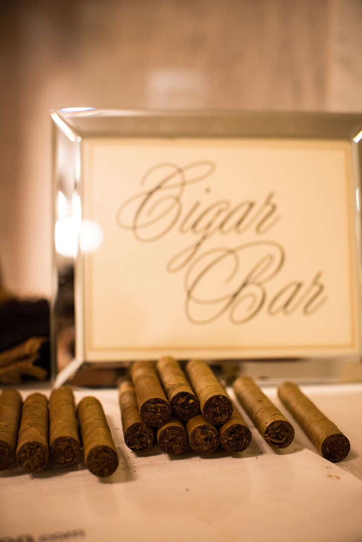 Guests snapped pics with props in an on-site photo booth before taking home hand-rolled cigars as favors.