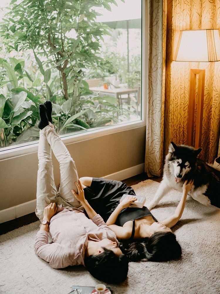 Couple cuddling with dog