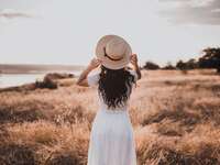 Woman standing alone in field
