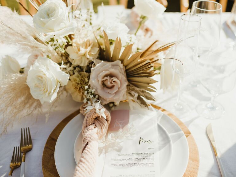 beachy fall wedding centerpiece with blush and white roses and dried fan palm