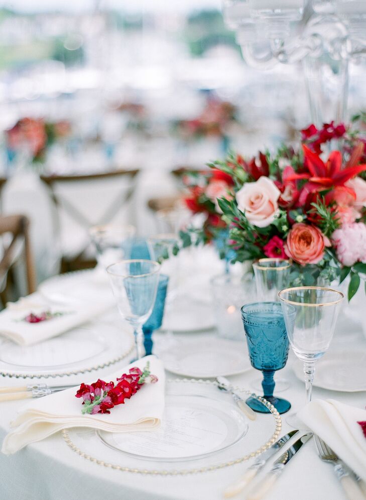 Vintage Blue Glassware and Bright Floral Arrangements on Wedding Reception Tables