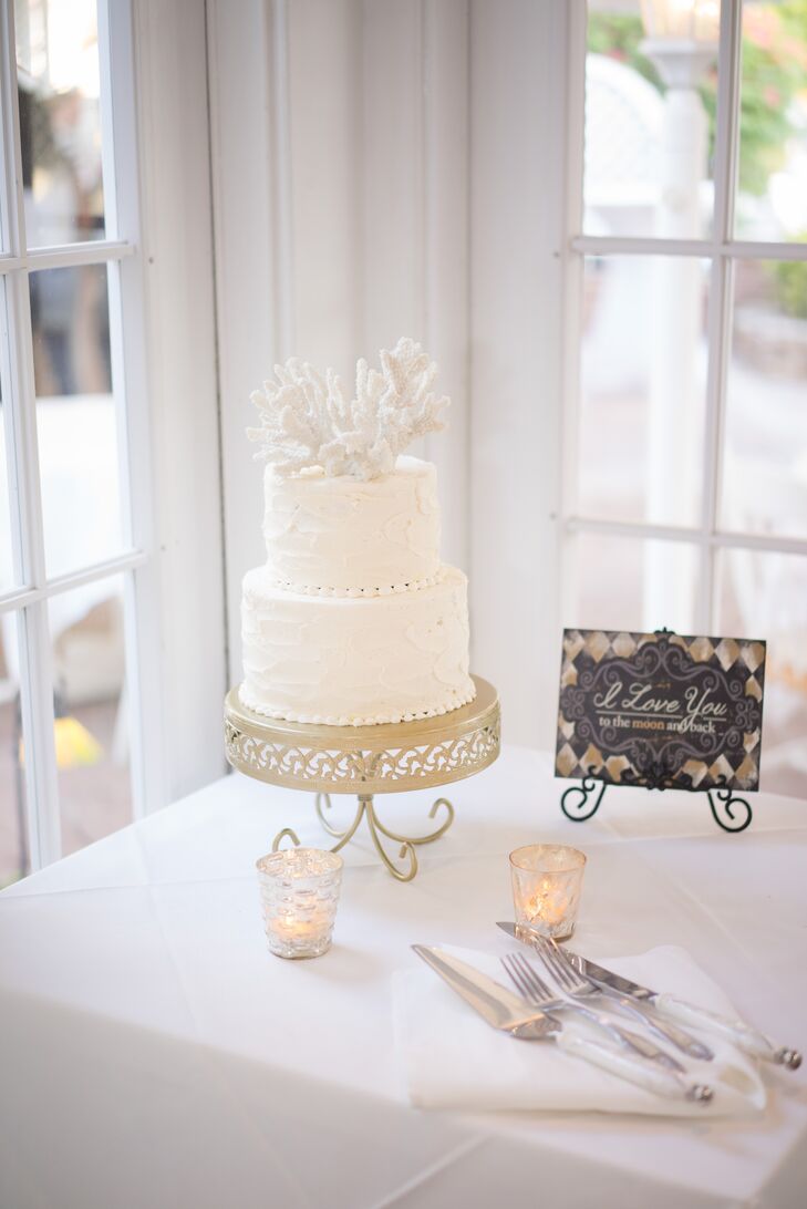Of course, their wedding cake also tied in the nautical theme. LadyCakes covered its two lemon tiers in buttercream frosting and topped the confection with two white coral accents. Guests who had a taste for a different sweet were also treated to mini key lime tarts, a Boston Red Sox groom’s cake and more mini desserts.