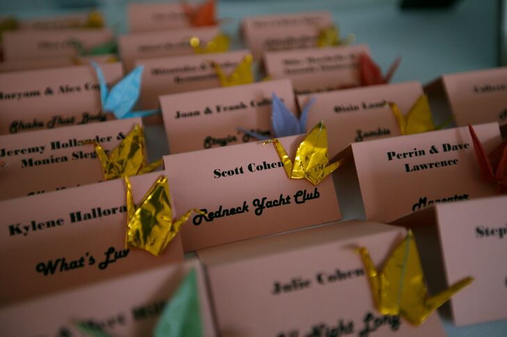 Tiny, hand-folded paper cranes in a multitude of bright and metallic hues were fixed to pitched escort cards and also designated each guest’s table.