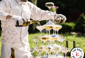 Wedding bartender pouring a champagne tower