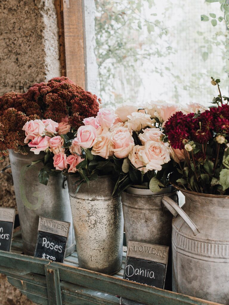 pink roses and red dahlias in galvanized tin buckets