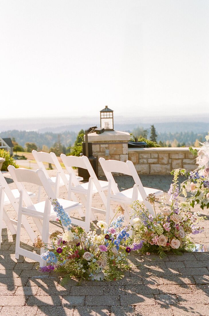 White Ceremony Chairs, Pastel Aisle Decor on Stone Balcony Overlooking Valley