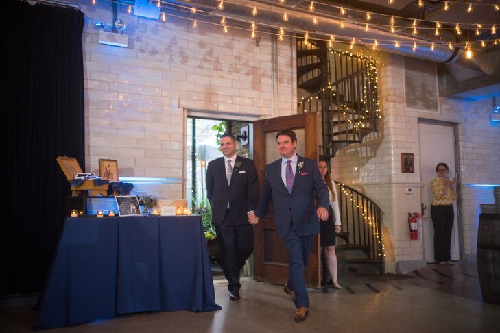 The loft-style space where the reception took place was illuminated with market lights across the ceiling and string lights wrapped around the spiral staircase.