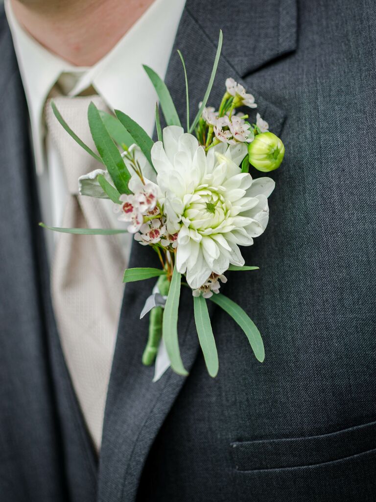 affordable wedding boutonniere with white wax flowers and greenery