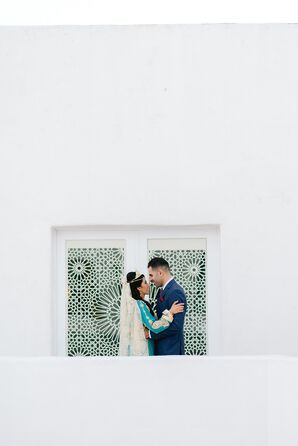 Bride in Bold Blue Traditional Dress Embraces Groom in Navy Suit