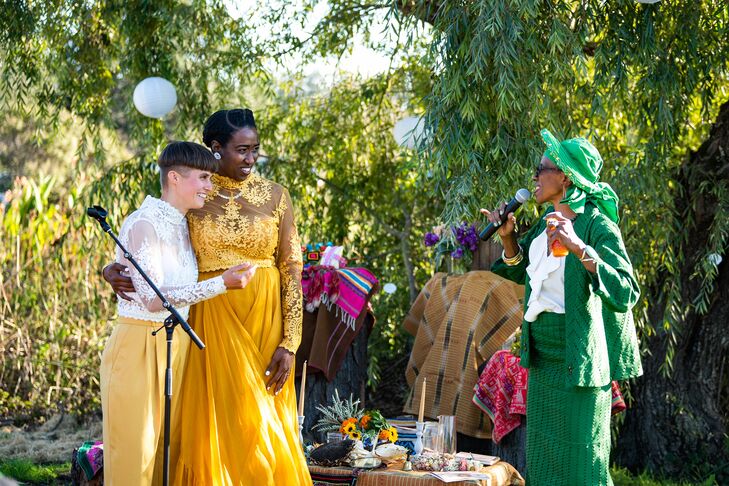 Couple in Unique Yellow Outfits, Lace, Listening to Speaker at Altar During Ceremony