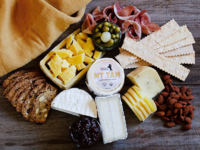 Cheese board gift box with pairings like crackers and jams