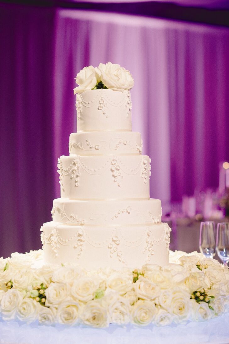 White roses surrounded the base of the five-tier cake. It looked like it was floating in white roses, Rachel says.