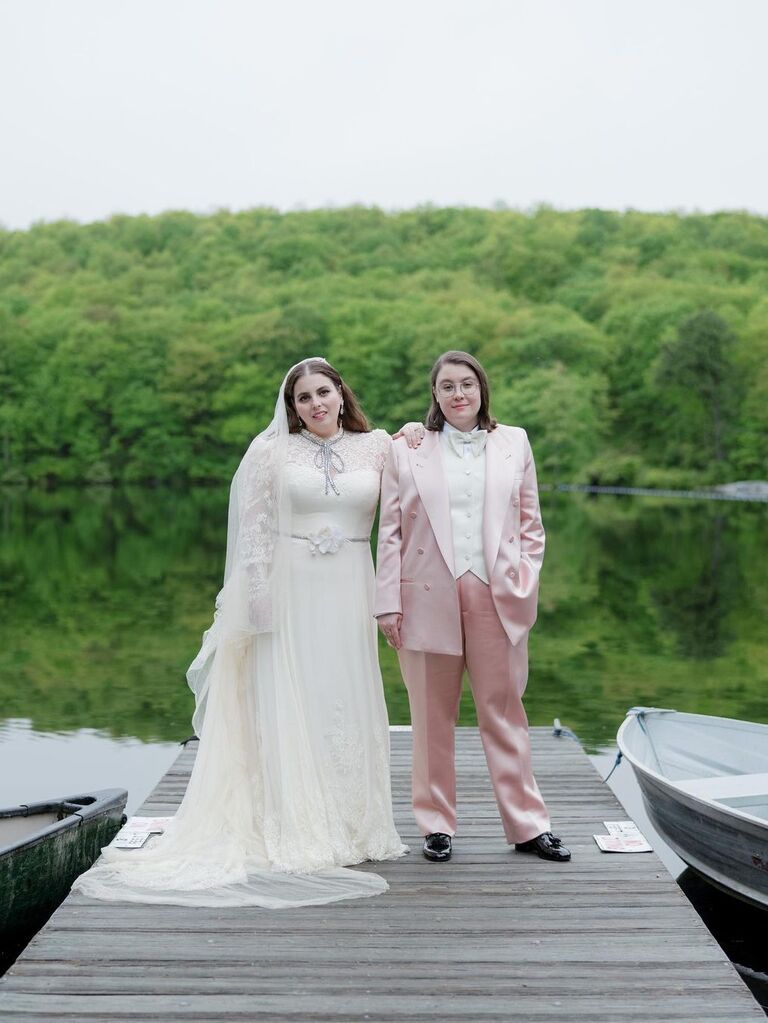Beanie Feldstein standing with partner Bonnie-Chance Roberts by lake on wedding day