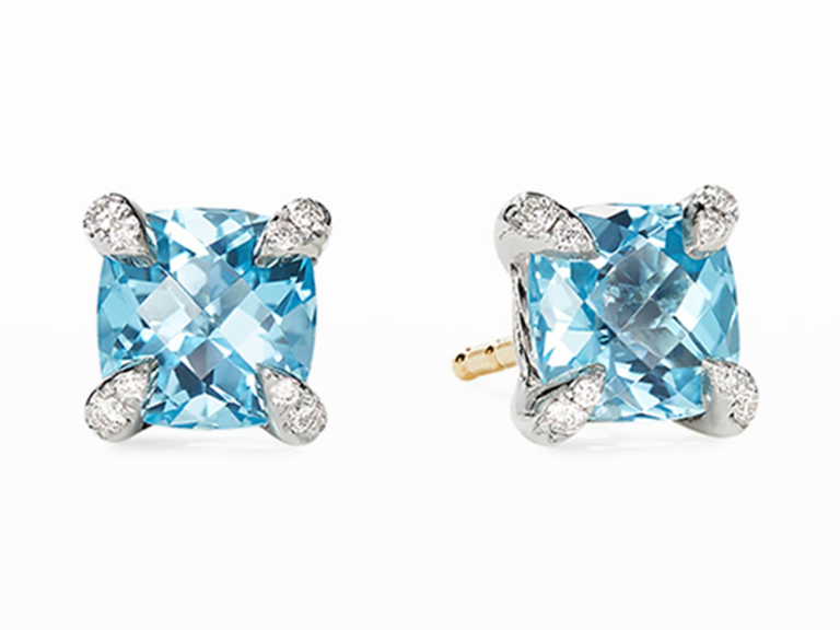 Blue cushion cut topaz studs set in diamond-encrusted prongs