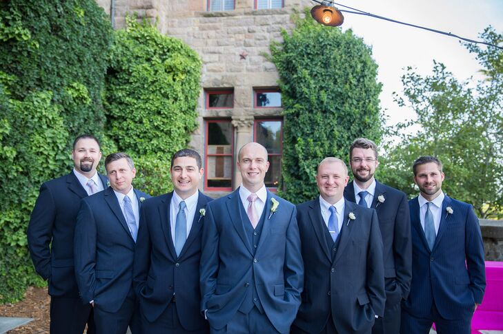 The groomsmen wore charcoal gray suits with blue ties.