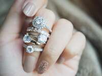 Stack of different diamond engagement ring shapes on finger