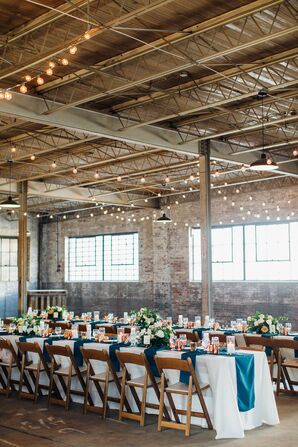 Warehouse Reception With String Lights and Wood Folding Chairs