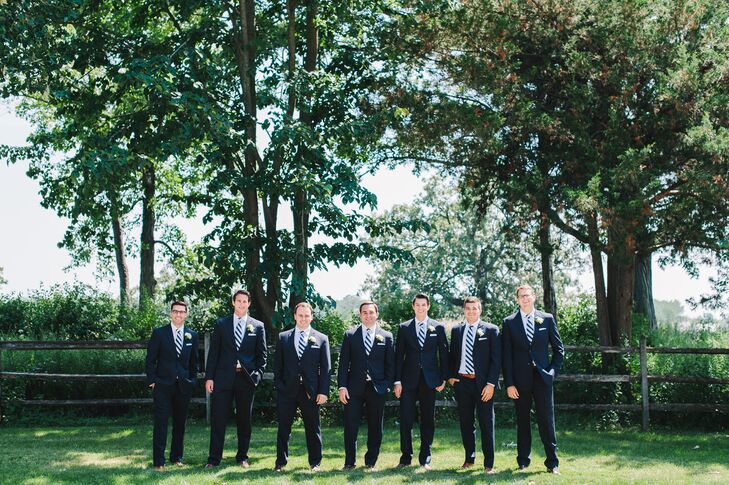 Each of Matt's six groomsmen wore navy suits from Joseph A. Bank that they then paired with navy and white-striped ties. White pocket square from The Tie Bar completed their classic look.