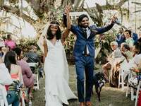 Couple walking down the aisle after wedding ceremony.