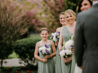 junior maid of honor standing with bridal party at wedding