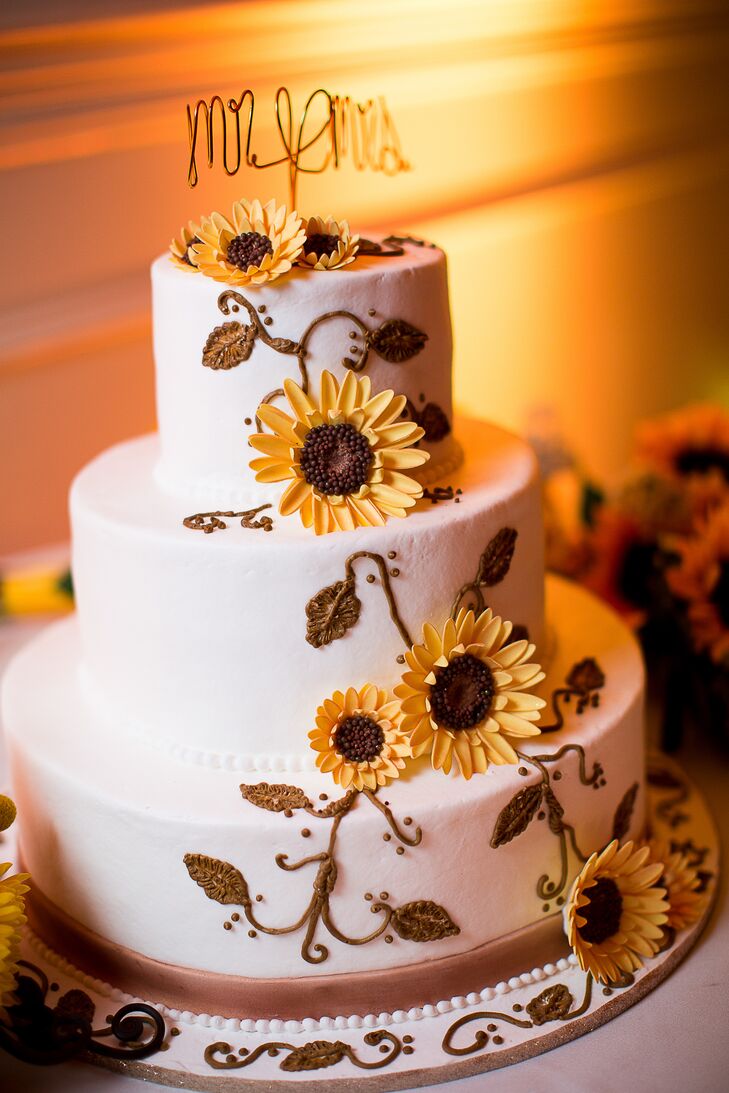 The three tier wedding cake was decorated with sunflower cake flowers.