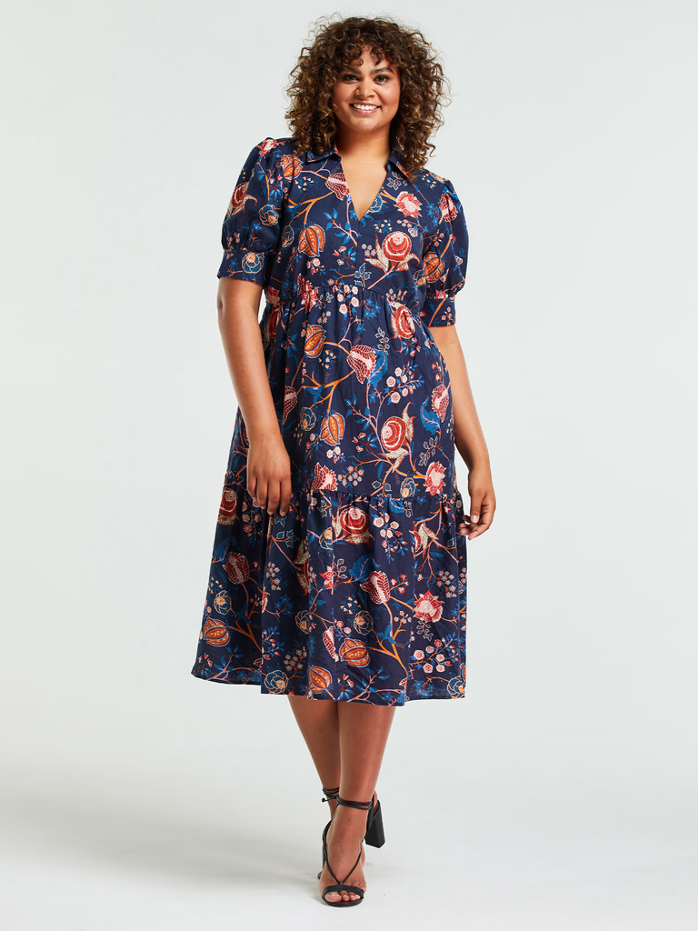 A model wears this fun and flirty calf-length floral gown.