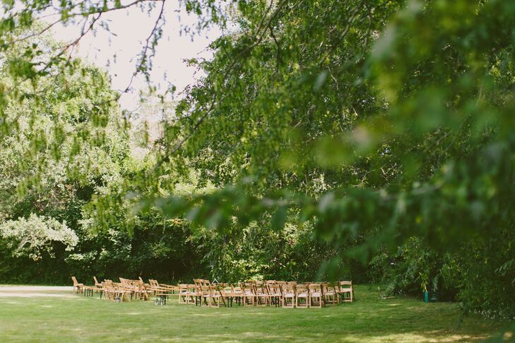 The ceremony unfolded in a wooded clearing, with Erin and Tyler exchanging vows in a custom ceremony written and officiated by a close friend. Tall green trees and lush bushes that had been on the property for over 100 years formed the backdrop for the intimate affair, with flower petals strewed about the aisle for a hint of texture and visual drama. A ukulele provided the tunes for the occasion and a rowboat bar brimming with beer and mini champagne bottles greeted guests upon arrival. “It was always my dream to get married while everyone had a drink in hand. We wanted people to start celebrating from the moment they arrived,” Erin says.