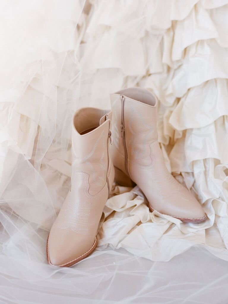 white western style boots next to bride's wedding dress train