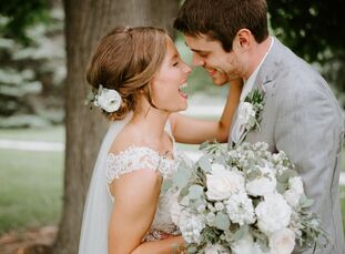 Lush hand-tied florals, delicate vintage-inspired details and subtle rustic accents lent Anna Grovijohn and Chase White’s summer wedding a relaxed, ro