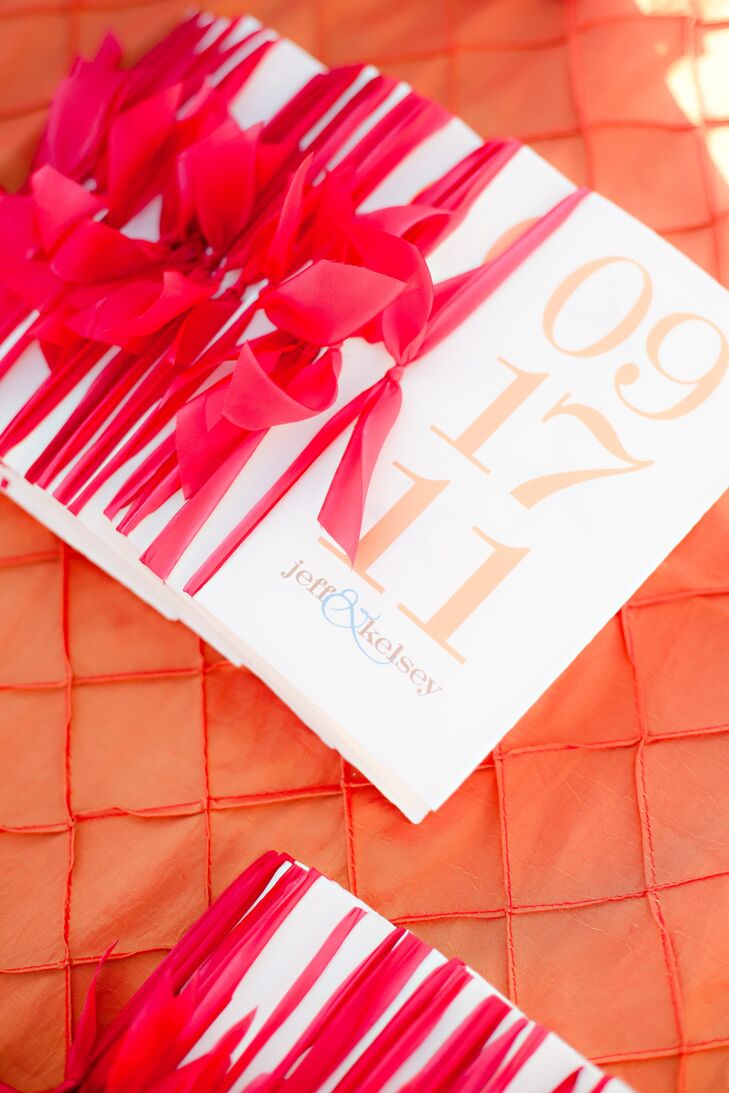 A bold orange font decorated the programs, which were tied with raspberry-colored ribbons.