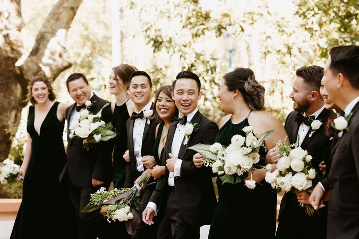 Groom in Classic Black Tuxedo With Mixed-Gender Wedding Party in All Black, White Flowers
