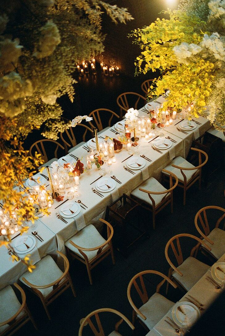 Long Reception Dining Tables With Modern Vibe, Candles, Orchids and Floral Installation Above