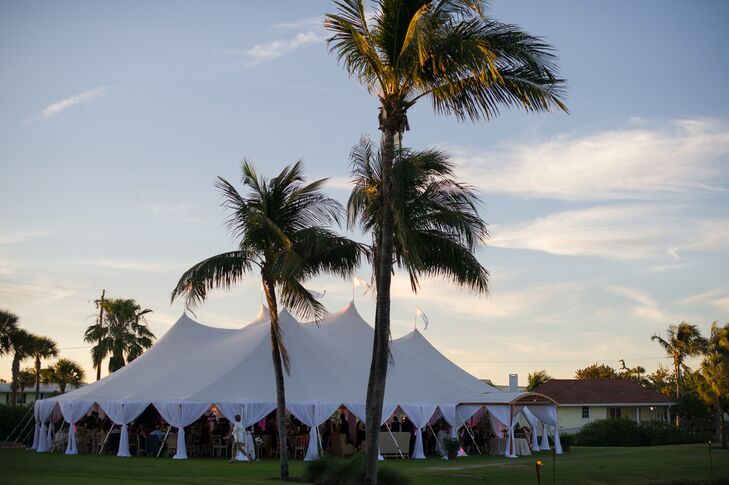 After the ceremony, Emily and Jason joined their guests for dinner and dancing under an expansive open-air tent that offered fantastic views of the surrounding palm trees and the crystal blue waters beyond Gasparilla Inn & Club in Boca Grande, Florida.