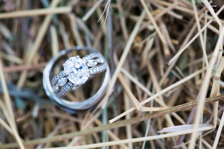Sara wears a classic oval-cut diamond engagement ring with an ornate band.