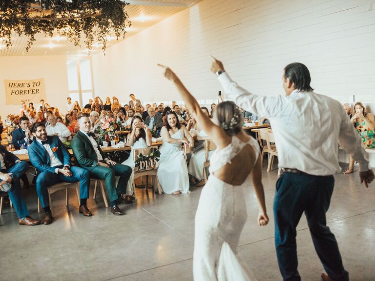 Bride and groom dancing in front of guests. 