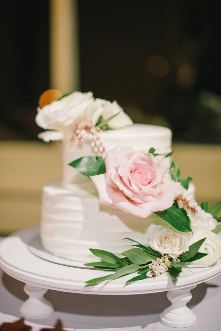 Satura Cakes crafted the couple's wedding cake, a two-­tier strawberry shortcake adorned with fresh flowers. Guests indulged in a full dessert bar, which featured a variety of mini­cakes, from red velvet to green tea and carrot cake.