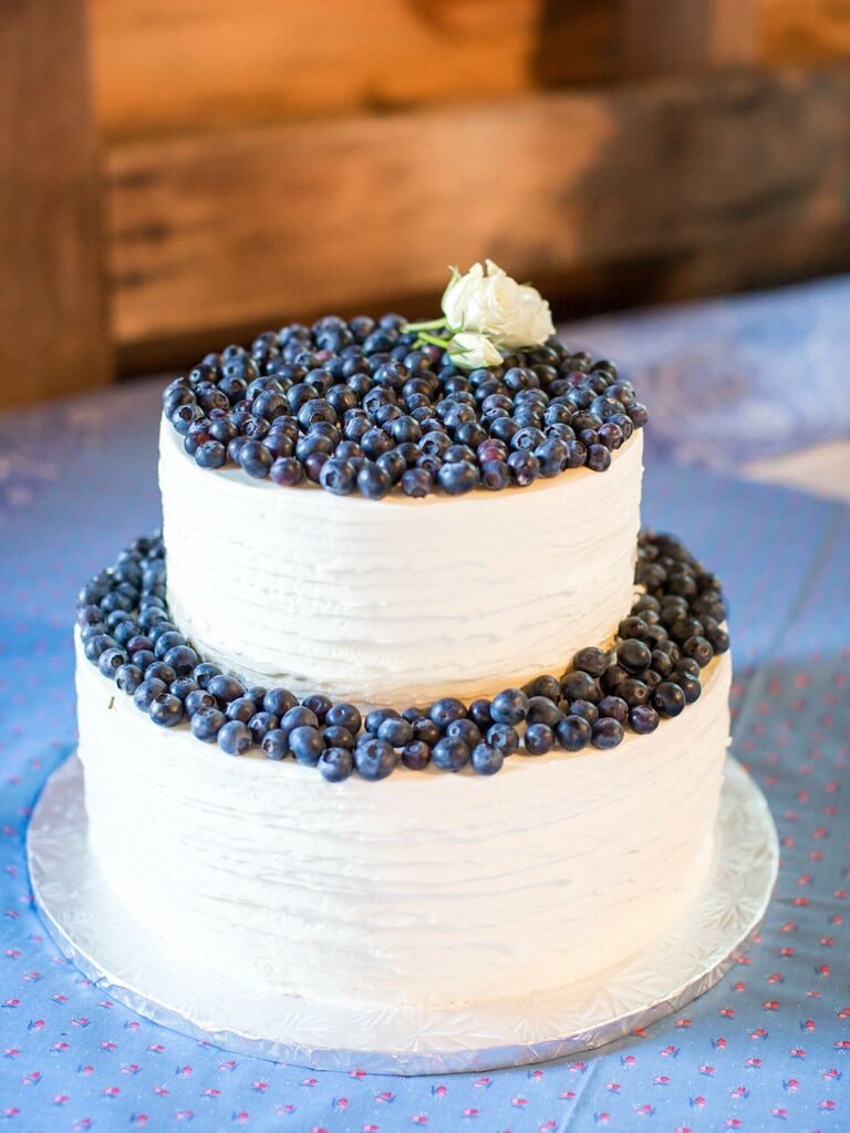 white buttercream wedding cake decorated with fresh blueberries
