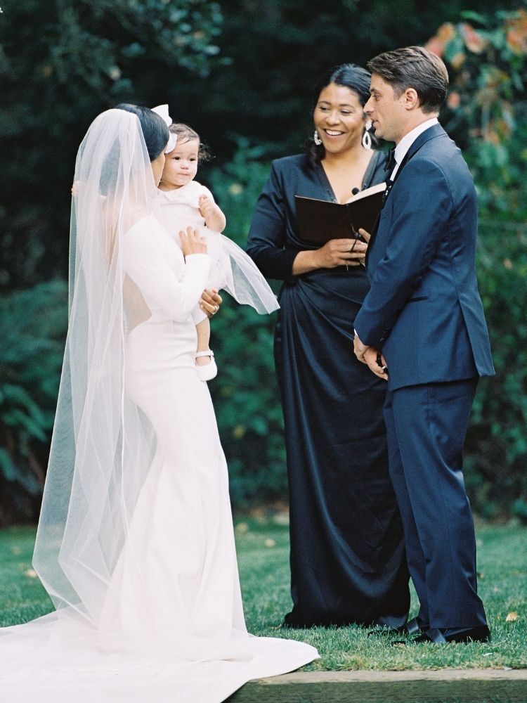 couple with baby during wedding ceremony