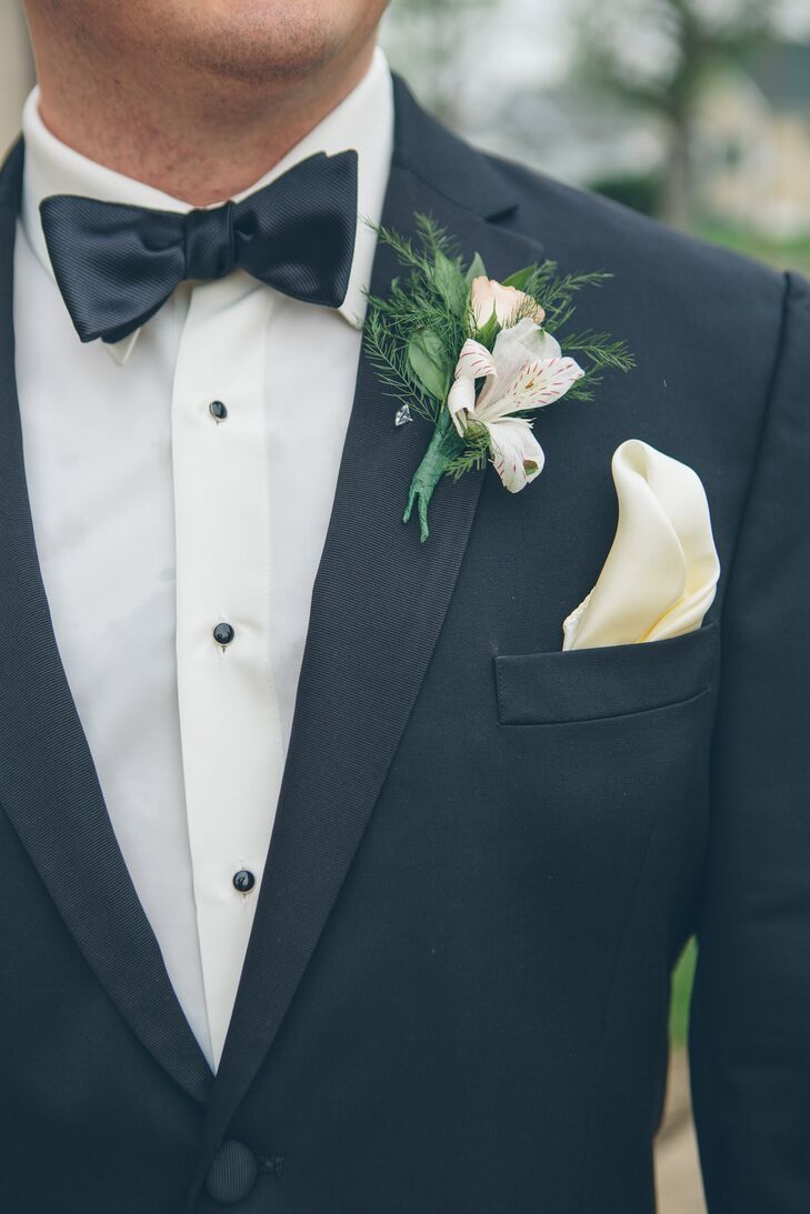 Kyle and his groomsmen wore black tuxedos with black bow ties, ivory pocket squares and white alstroemeria boutonnieres.