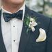 Kyle and his groomsmen wore black tuxedos with black bow ties, ivory pocket squares and white alstroemeria boutonnieres.