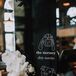 Black and White Dog-Themed Bar Sign with Orchid Arrangement