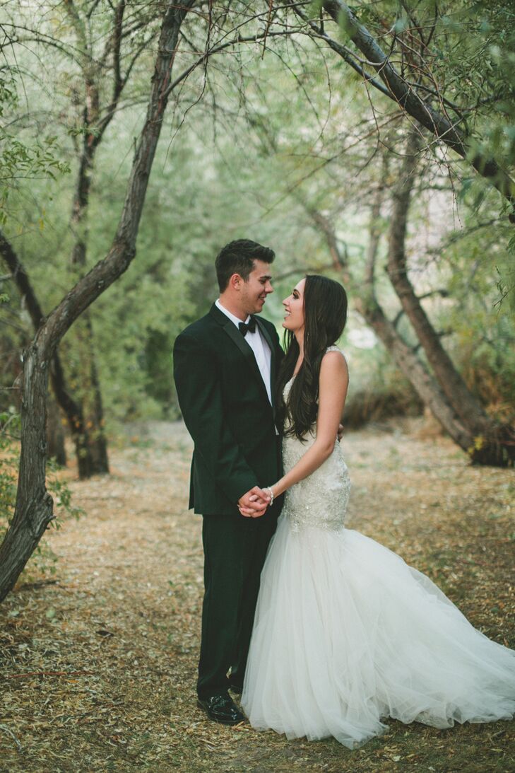 Kalen and the groomsmen opted for traditional black-and-white tuxedos with black bow ties and dress shoes to coordinate with the wedding's romantic and glamorous look.