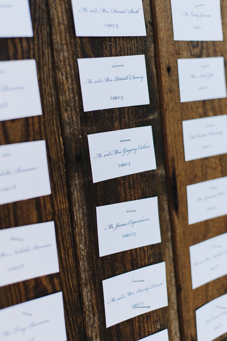 Rather than display their escort cards on a table, the couple opted to nail them to a large, wooden wall for guests to find their seats with ease.