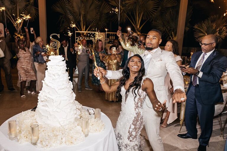 Simone Biles and Jonathan Owens cutting wedding cake