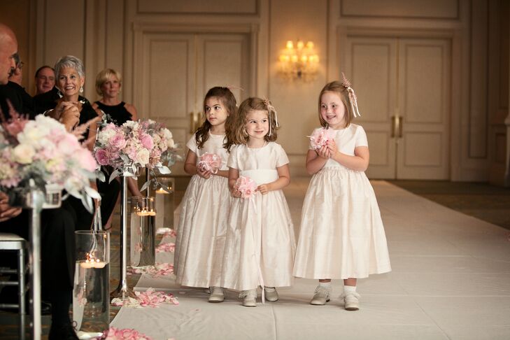 The three flower girls wore adorable pale pink dresses and carried small tea rose pomanders down the aisle.
